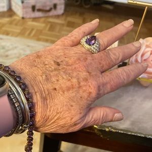 Amethyst pear shaped ring set in gold tone with clear cz’s.